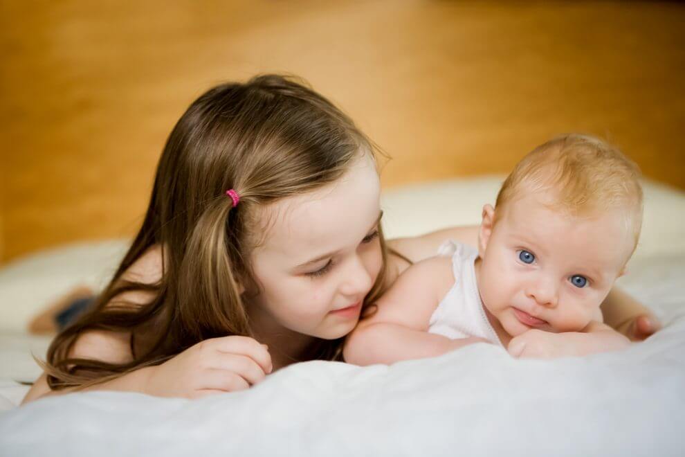 Young girl with her baby brother