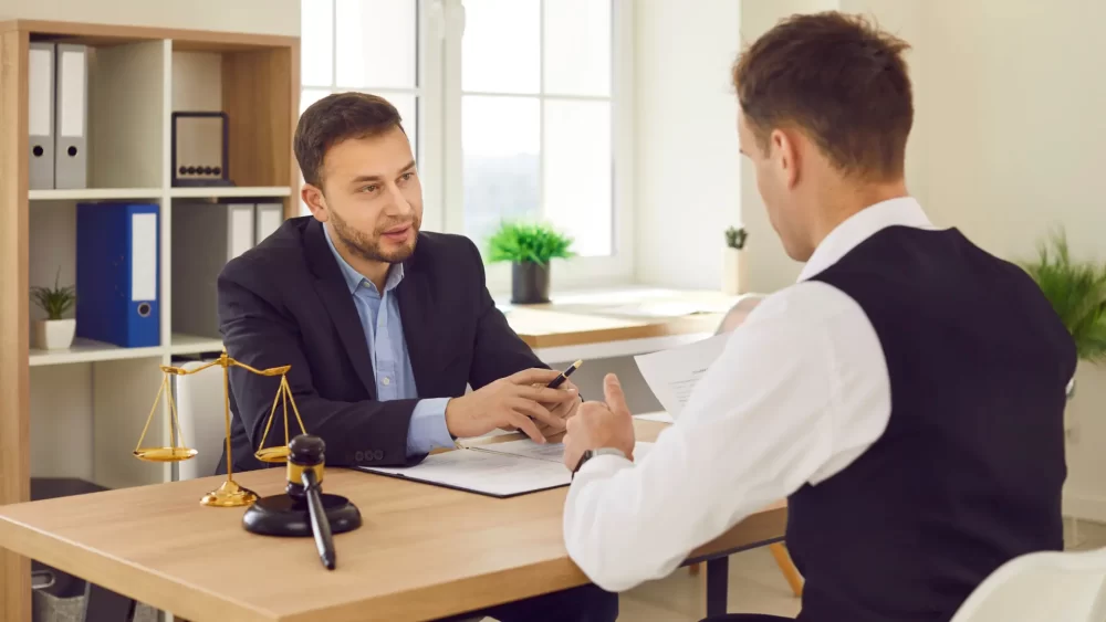 Two gentleman sitting at a desk during a mediation for spousal support In Ontario