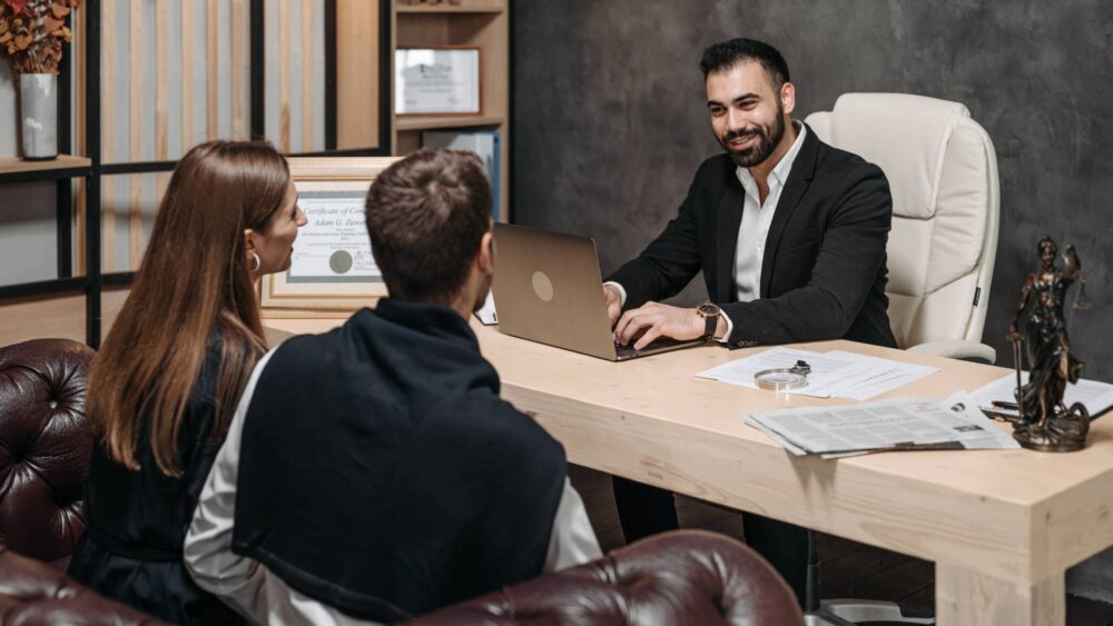 A couple sitting with a family lawyer, preparing for a Case Conference Ontario