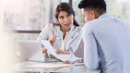 Property division lawyer serving Oakville reviews financial documents.