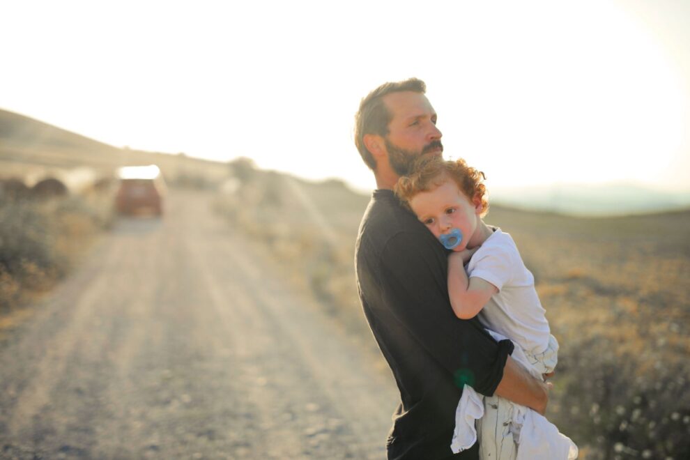 parent holding child silhouette